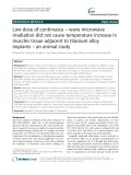Low dose of continuous – wave microwave irradiation did not cause temperature increase in muscles tissue adjacent to titanium alloy implants – an animal study